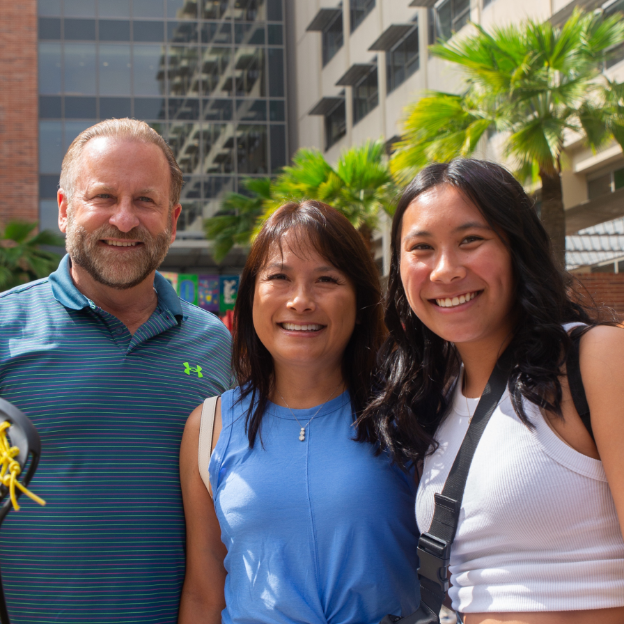 A UCLA student and her family in front of the Rendezvous restaurant