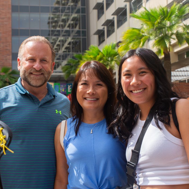 A UCLA student and her family in front of the Rendezvous restaurant