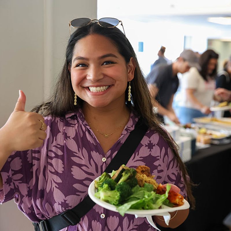 A faculty shaking another faculty's hand